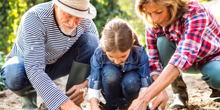 Photo of a couple gardening with a young girl