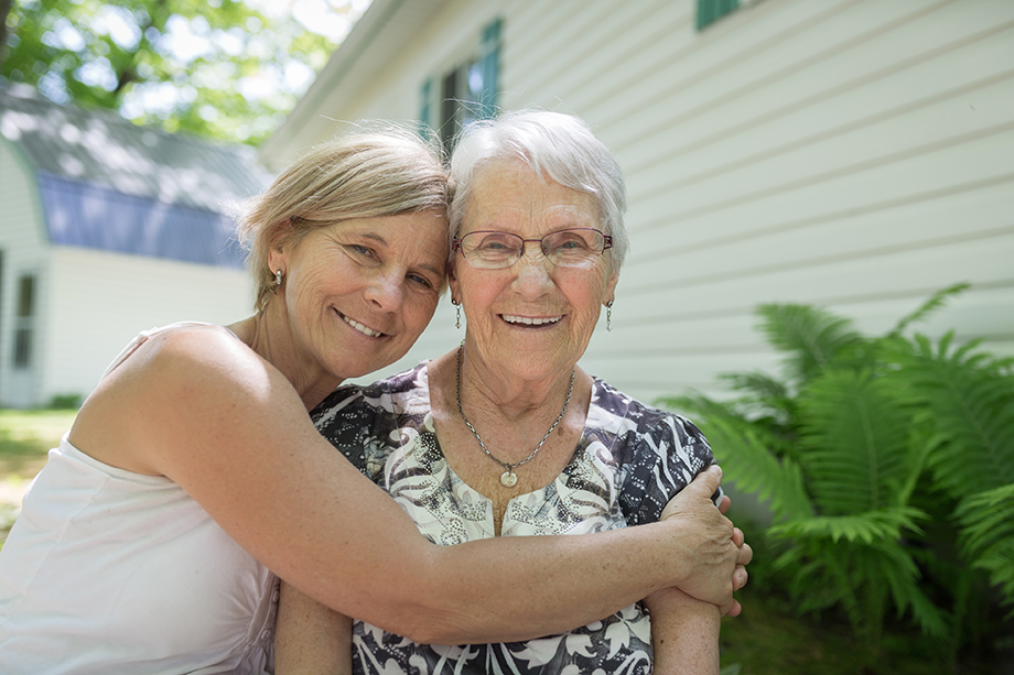 Photo of adult woman hugging elderly woman