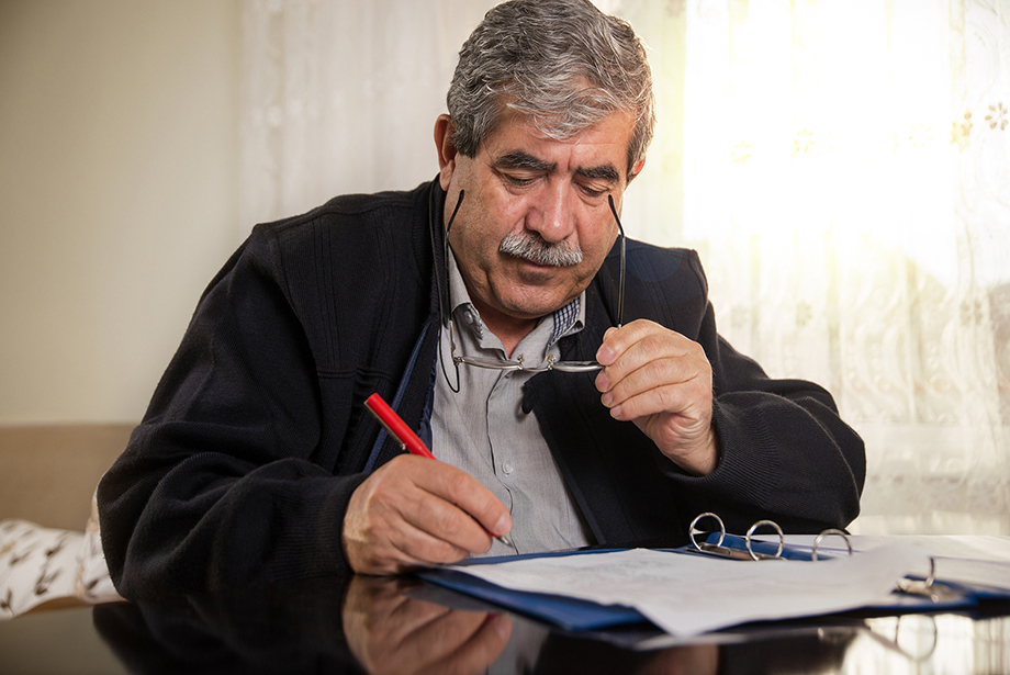 Photo of a senior man completing paperwork